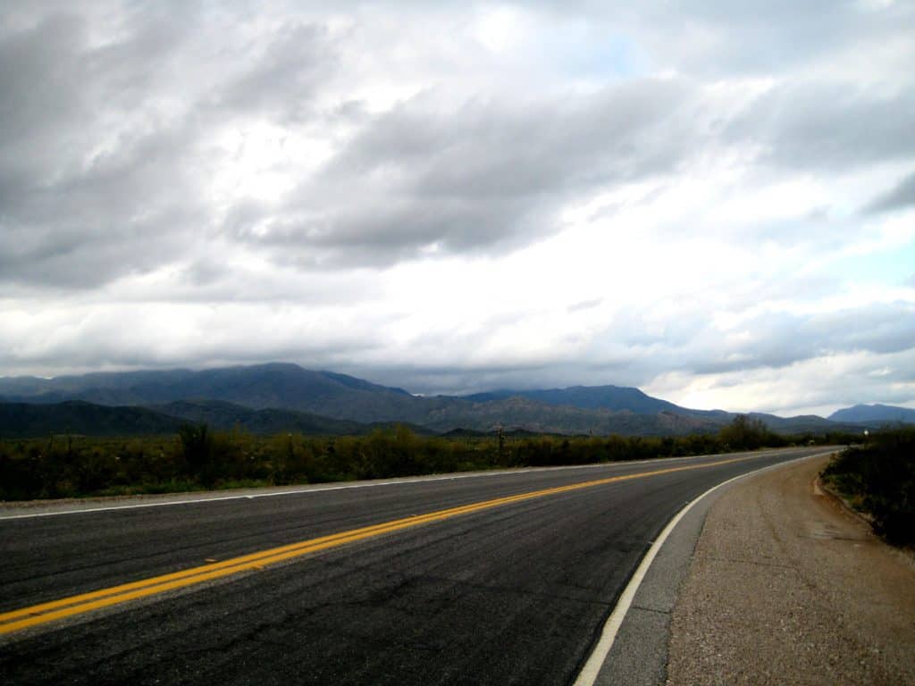 Paved 2 lane highway heading up to mountains