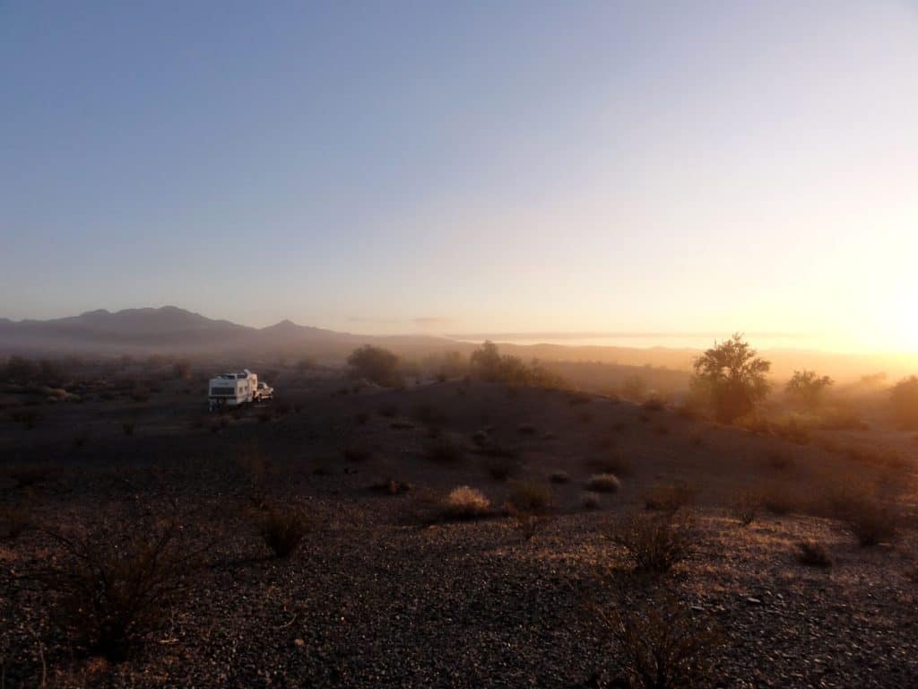 Warm glow of sunrise at RV campsite in the desert
