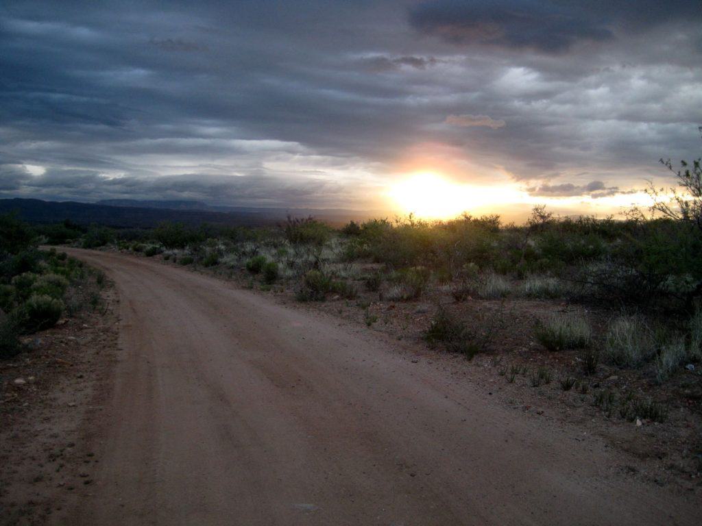 Sun peaks through the clouds at sunrise along FR 361 in the Prescott National Forest